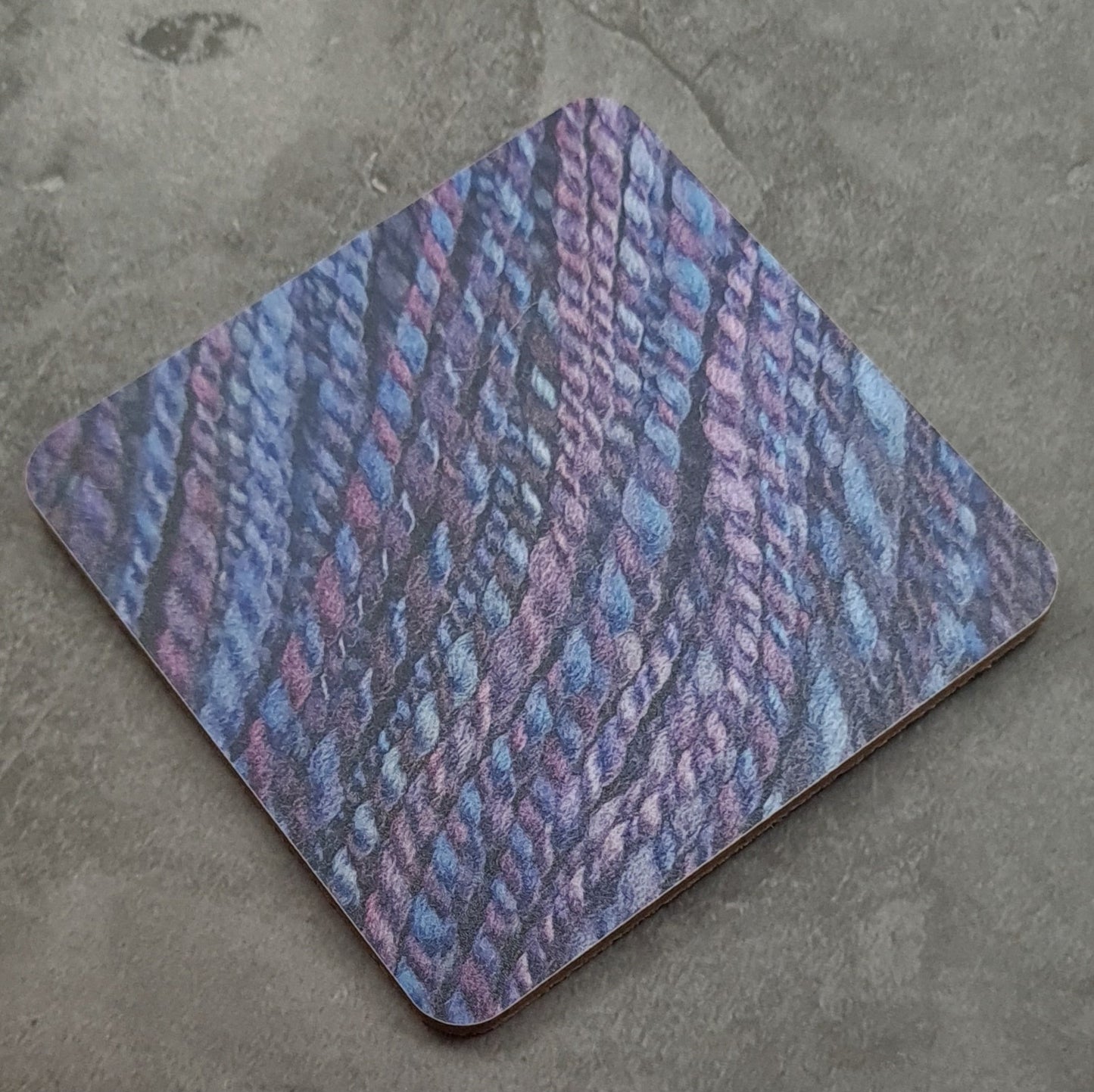 Coaster printed with images of handspun yarn and cork backing