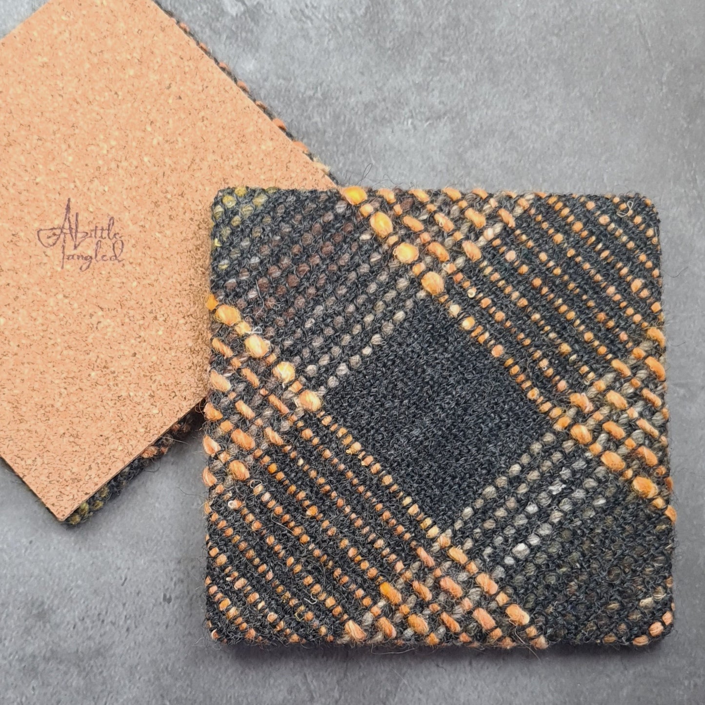 Coaster featuring handwoven fabric and Cork backing - Charcoal & Orange