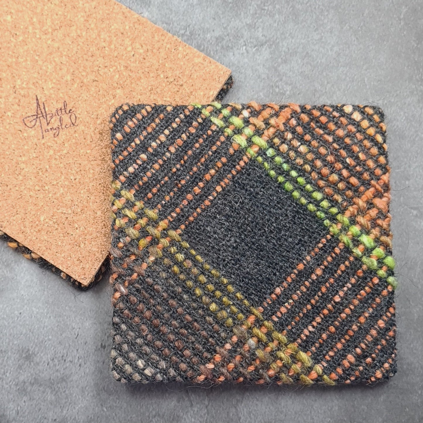 Coaster featuring handwoven fabric and Cork backing - Charcoal & Orange