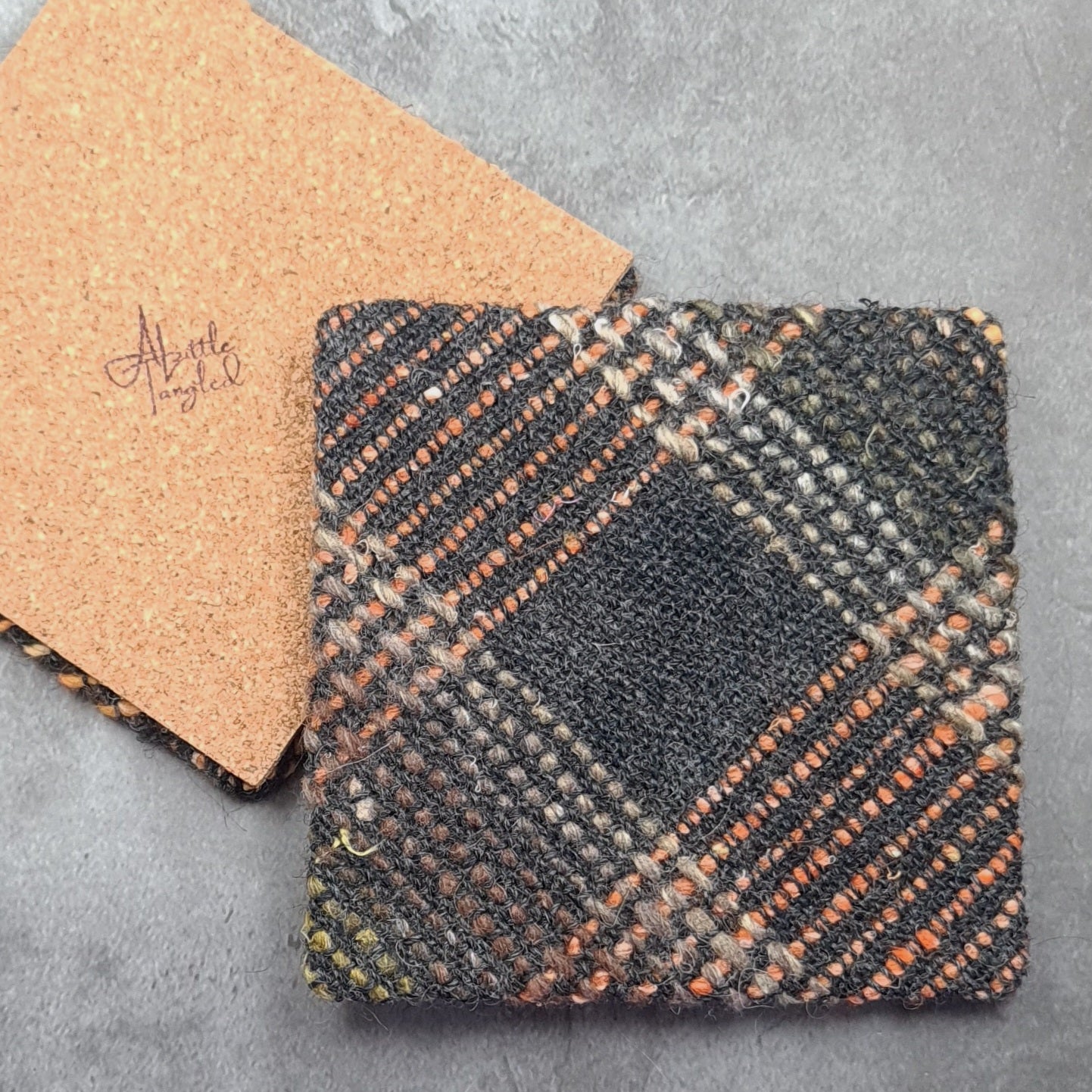 Coaster featuring handwoven fabric and Cork backing - Charcoal & Orange