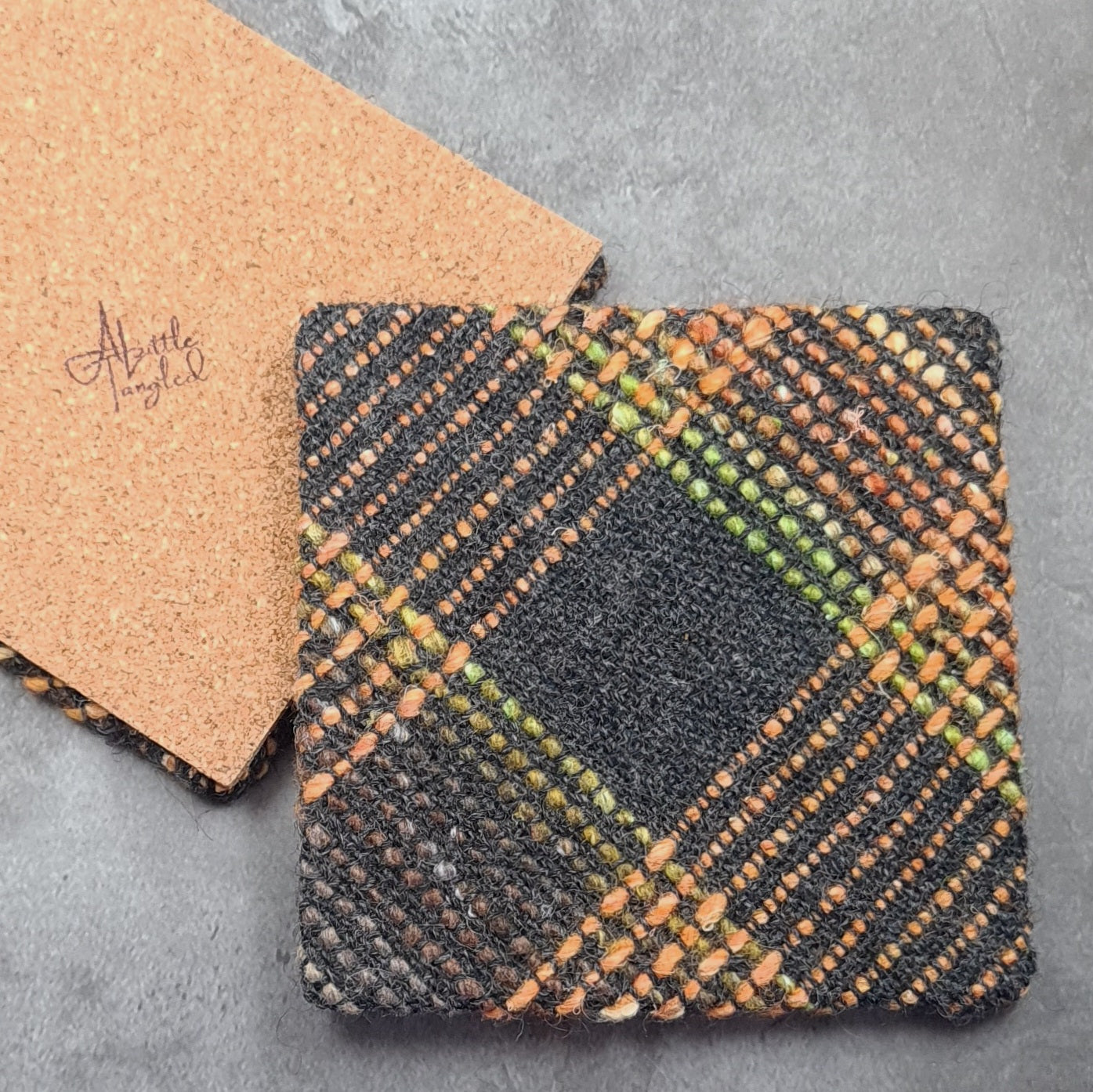 Coaster featuring handwoven fabric and Cork backing - Charcoal & Orange